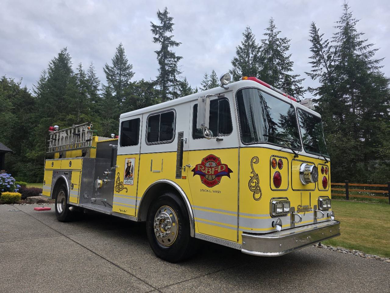 The yellow and white Red Beard 1991 Seagrave fire engine parked outdoors